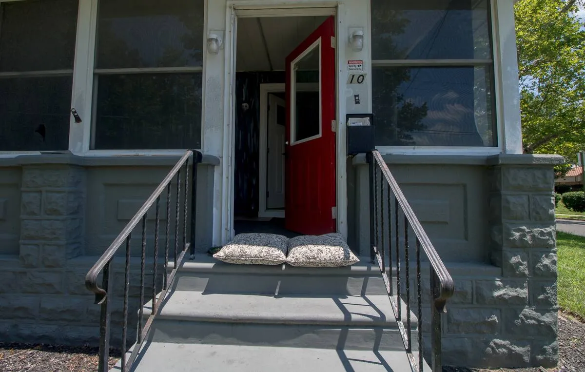 The front steps and the red front door